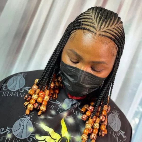 Two Layered Lemonade Braids Hair - A woman wearing a salon cape