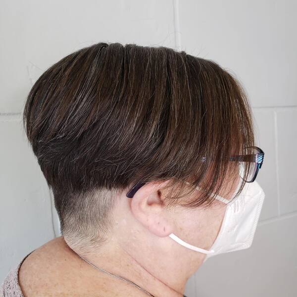 Undercut Pixie Bob - A woman wearing a white mask