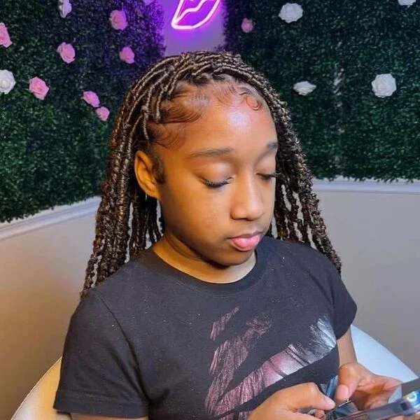 Weave Butterfly Locs - a woman wearing a black shirt.