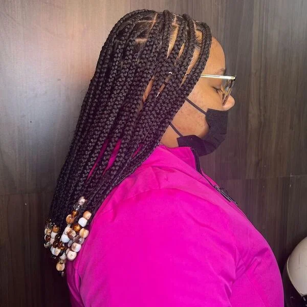 Braid Hairstyles with Weave Knotless Bob - a woman wearing a neon zipper down jacket.