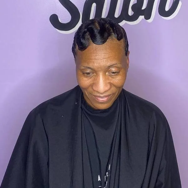 180 Finger Wave Curve - a woman wearing salon cape.