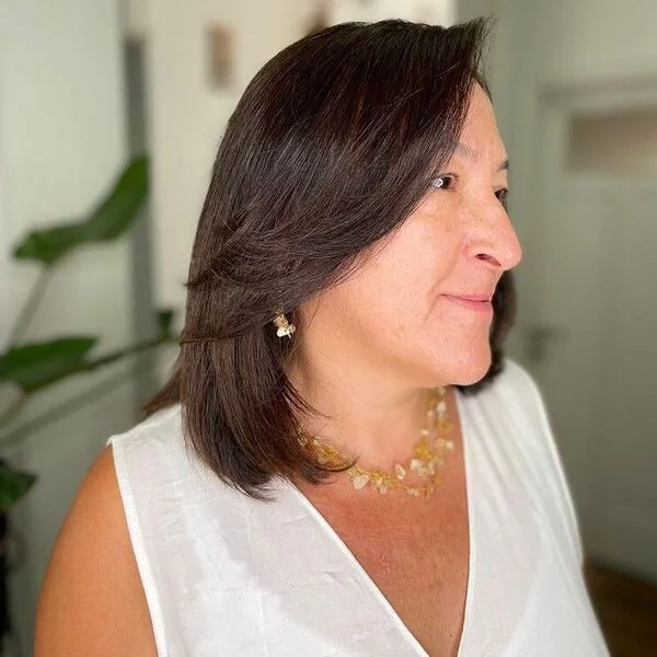 Asymmetric Side Bangs Bob - a woman wearing white linen top.