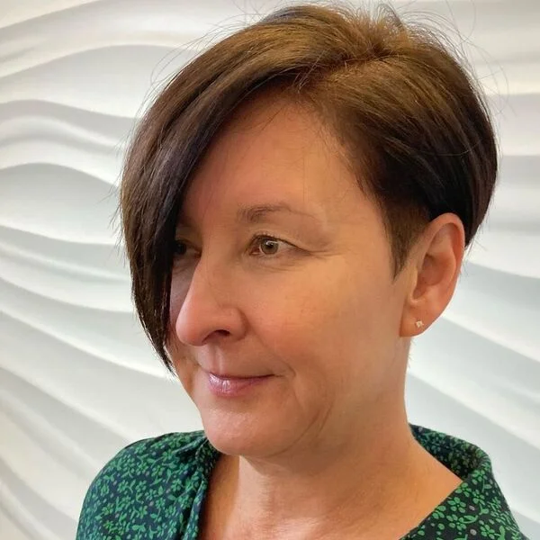 Asymmetrical Long Pixie Haircuts for Women Over 40 - a woman wearing green floral polo.
