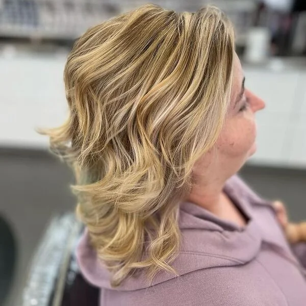 Blunt Balayage Layered Bob Haircuts for Women Over 40 - a woman wearing pink hood jacket.