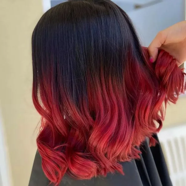 Bright Red Wine Bob Ends - a woman wearing black cape.