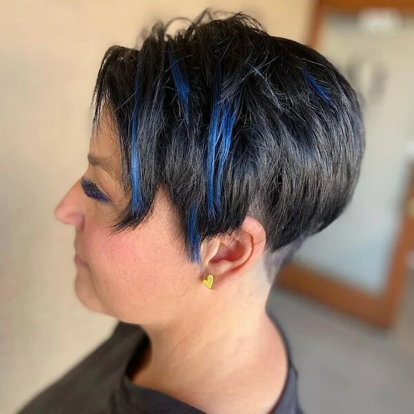Choppy Pixie Blue Streaks - a woman wearing heart shape earrings in black shirt.