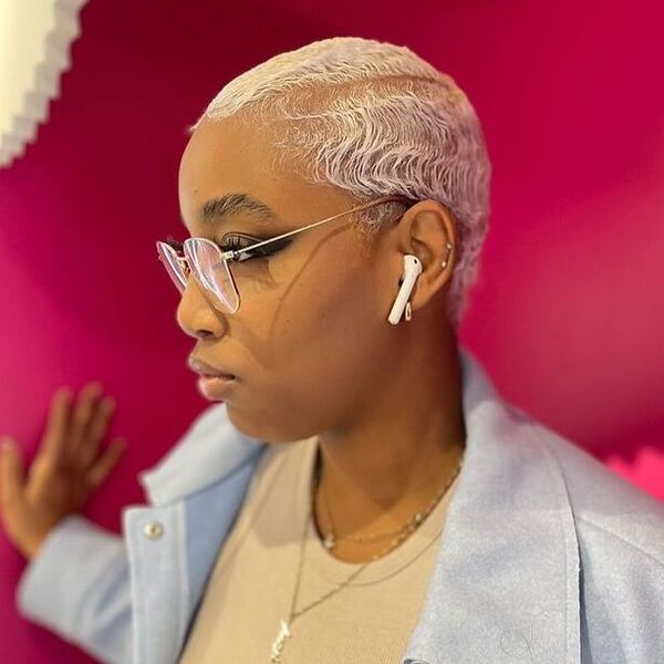 Classic Platinum Finger Waves - a woman wearing glasses and earphones in blue coat.
