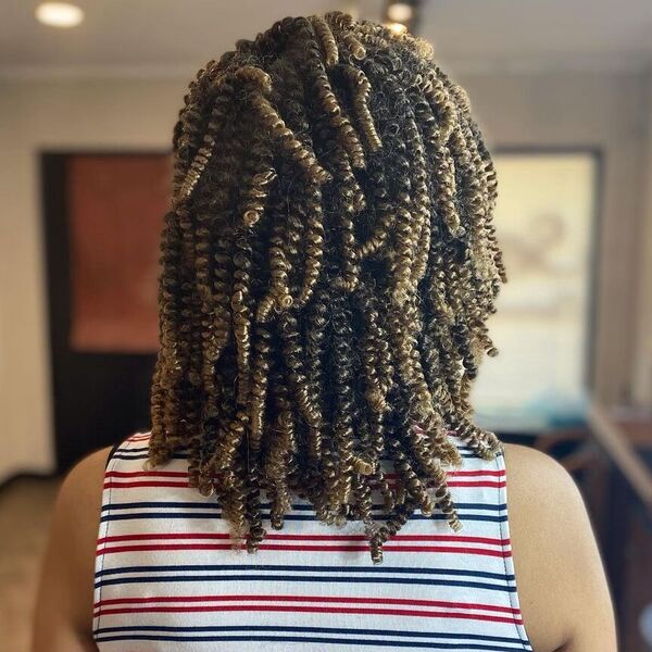 Coily Balayage Dreadlock Hairstyles for Women - a woman wearing stripe sleeveless top.