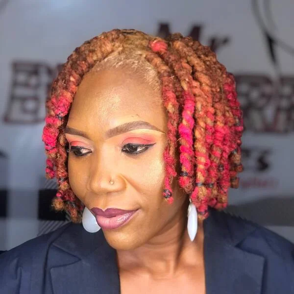 Defined Bob Locs with Pink Accent - a woman wearing dark blue coat.