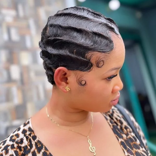 Dimensional Sleek Finger Waves - a woman wearing gold jewelries in animal inspired blouse.