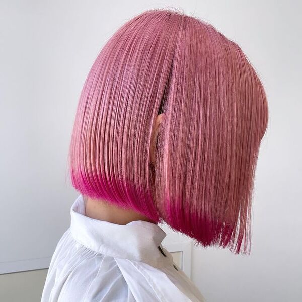 Dyed Flamingo with Magenta Ends Bob Cut - a woman wearing white polo.