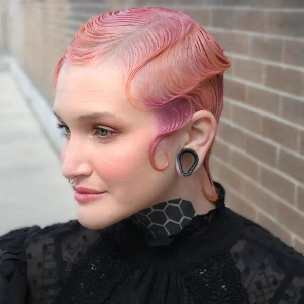 Elegant peachy-colored finger waves on short hair with sophisticated styling