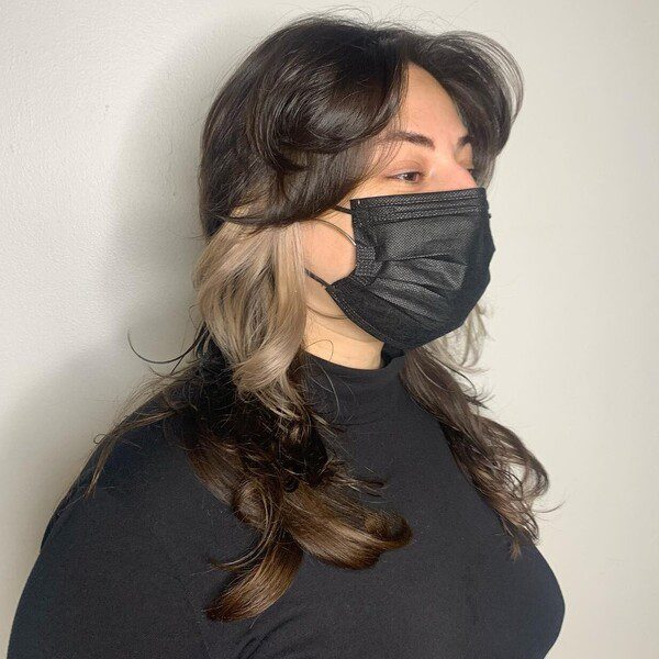 a woman wearing black mask and plain long sleeves turtle neck.