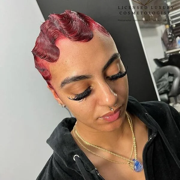 Bold red finger waves with swing pattern creating dramatic short hairstyle