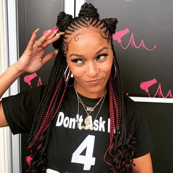 Fulani Braids with Bantu Knots - a woman wearing black printed shirt.