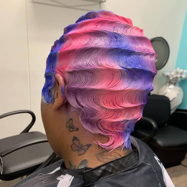 Galactic Finger Waves - a woman with neck tattoo wearing salon cape.