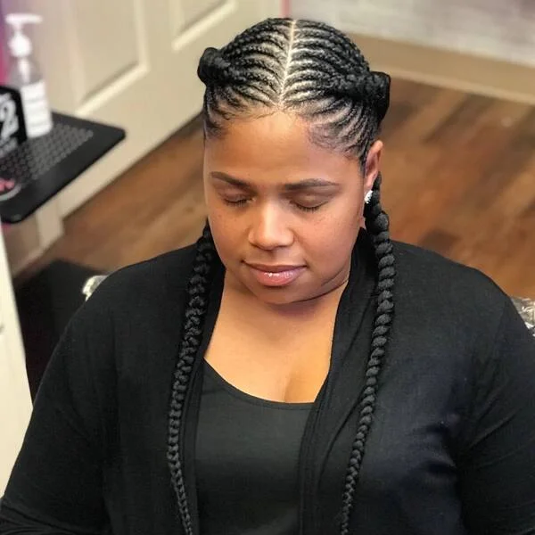 Goddess Fishbone Braids - a woman wearing black tank top and cardigan.