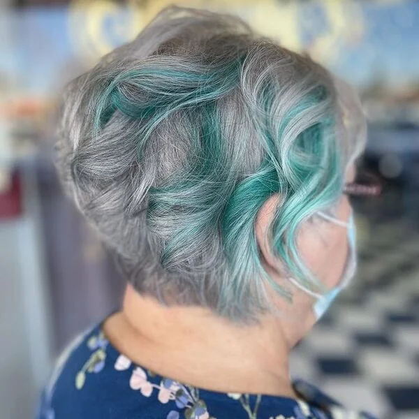 Gorgeous Teal Streaks in Natural Gray Hair - a woman wearing floral blue blouse.