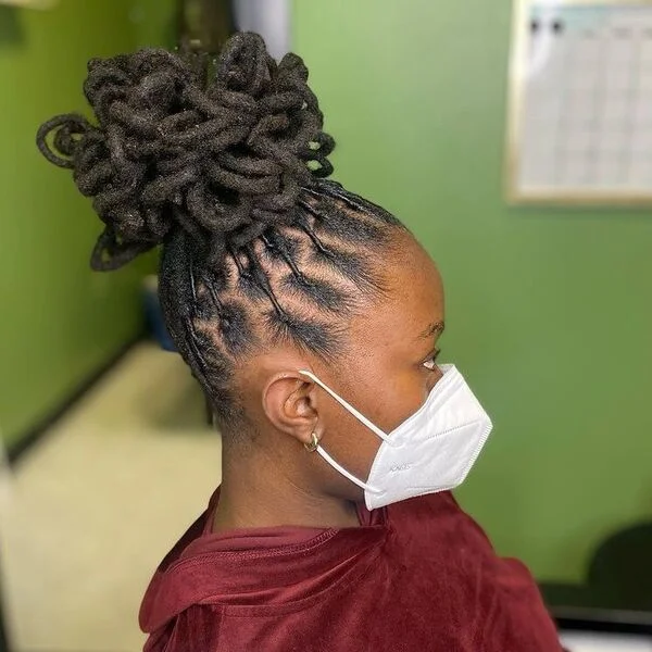 High Bun Petal Dreads - a woman wearing red velvet hood jacket.