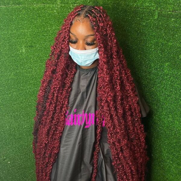 Knee Length Red Butterfly Dreadlock Hairstyles for Women - a woman wearing ask in black cape.