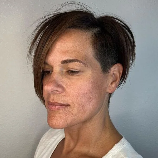 Long Asymmetric Undercut - a woman wearing plain white shirt.
