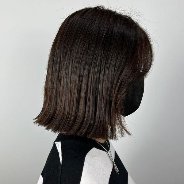 Low Maintenance Tassel Haircut - a woman wearing black mask and stripe shirt.
