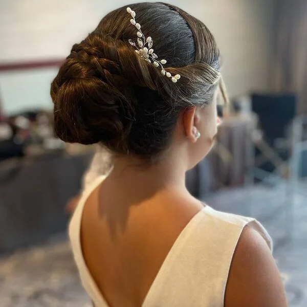 Neat Twisted Bun Hairstyle - a girl is wearing white gown.