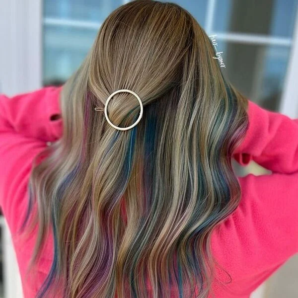 Pink and Blue Highlights on Chestnut Hair - a woman wearing pink sweater.