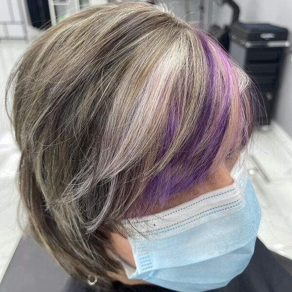 Pixie Ash Blonde Highlights with Purple touch - a woman wearing mask and earrings.