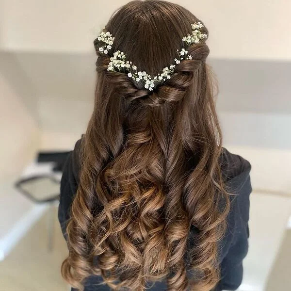 pull-through braids with small flowers - long braided flower girl hairstyle with floral accents