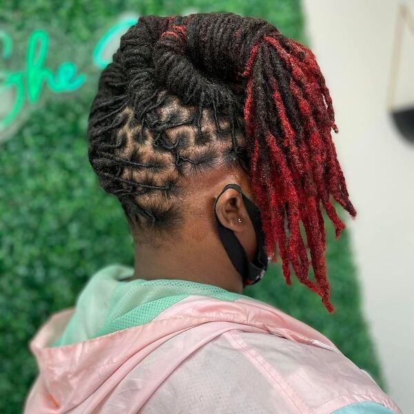 Reverse Ponytail Dreadlock Hairstyles for Women with Red Ends - a woman wearing outdoor jacket.