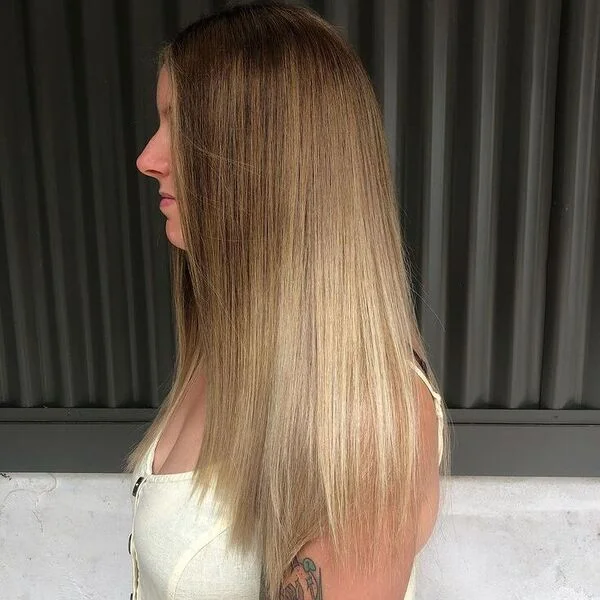 a woman wearing baby yellow tank top with root smudge straight V Cut Hairstyle