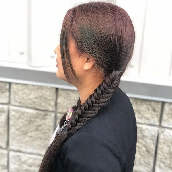 Side Low Fishbone Pony - a woman wearing black coat.