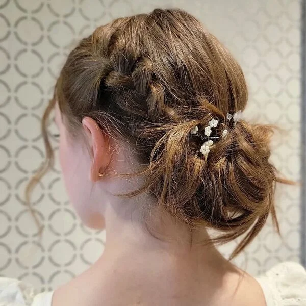 Simple Loose Updo Flower Girl Hairstyles- a girl is wearing white eyelet dress.