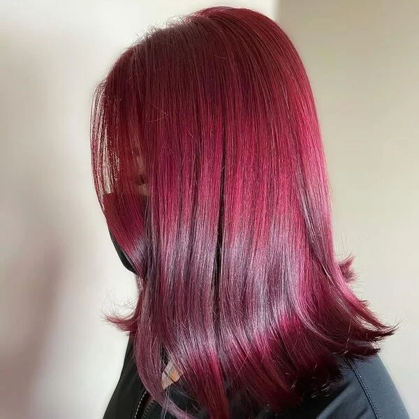 Sleek Flicky Burgundy Hair - a woman wearing black zipper down jacket.
