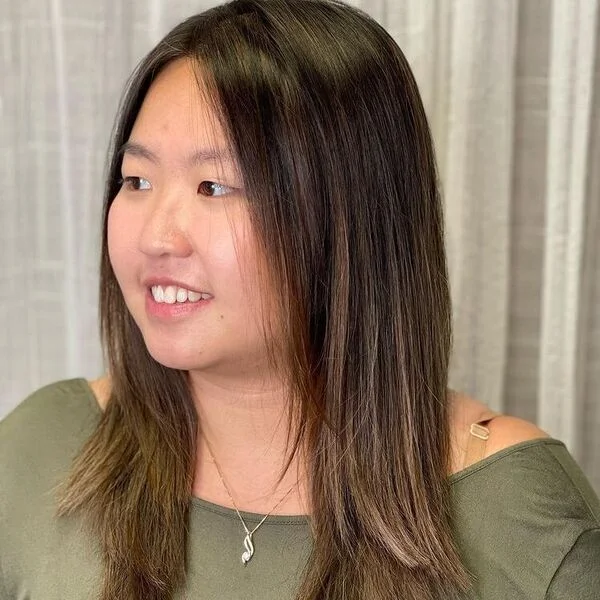 a woman wearing army green blouse.