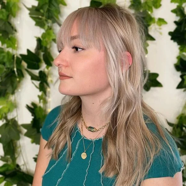a woman wearing teal blue top.
