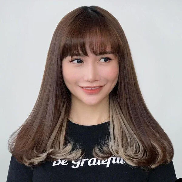a woman wearing statement black shirt.