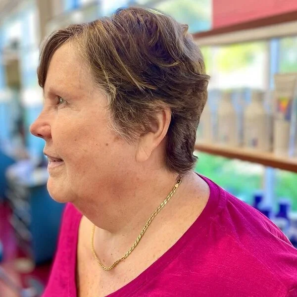 Subtle Hair Color Pixie - a woman wearing hot pink shirt.