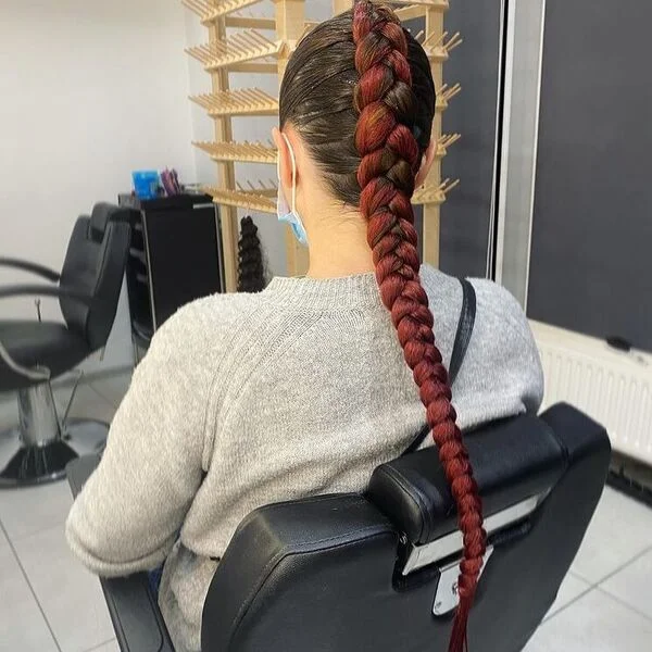 Thick Cornrow Burgundy Braid - a woman wearing gray sweater.