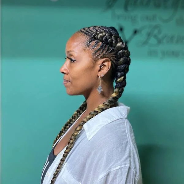 Thick Fishbone Braid Hairstyles - a woman wearing white polo with black tank top.
