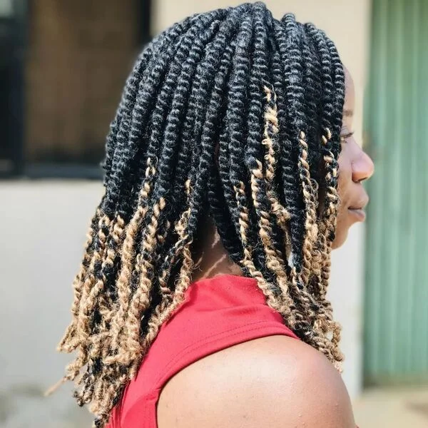 Tight Spring Twist Dreadlock Hairstyles for Women - a woman wearing red top.