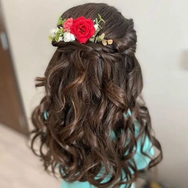 Twisted Curly Braids - a girl is wearing blue shirt with flower on hair.