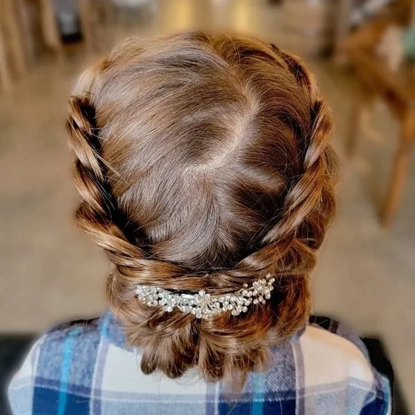 Two-Strand Braid Bun - a girl is wearing blue checkered polo.