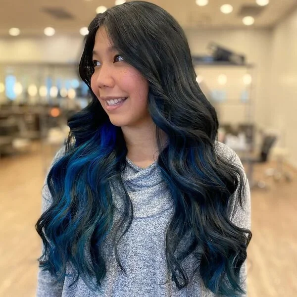 Wavy Cobalt Blue Highlights - a woman wearing gray sweater.