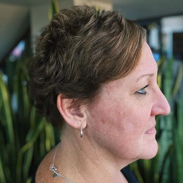 Wavy Pixie - a woman wearing silver jewelry in black top.