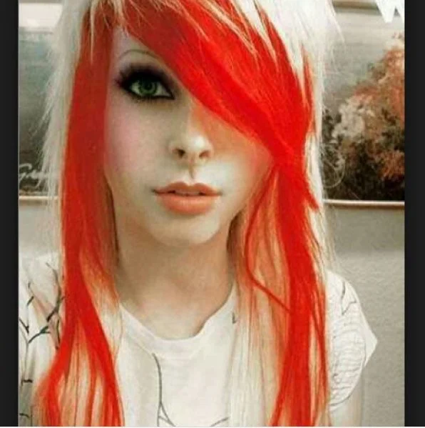 Striking emo hairstyle with fiery red and platinum blonde color contrast