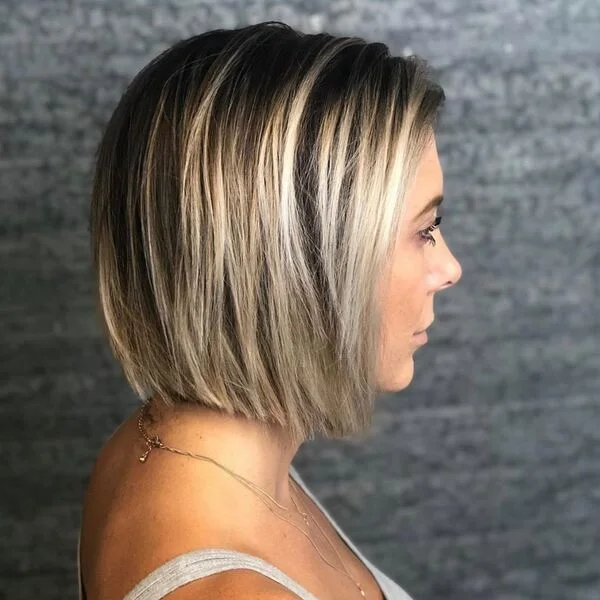 Sleek neck-length bob with dramatic black-to-blonde color melt - jawline-enhancing short sassy haircut for pale and cool skin tones
