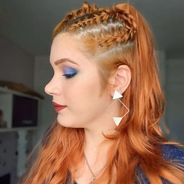A woman wearing blue shirt with accessories - Viking Hairstyles Women