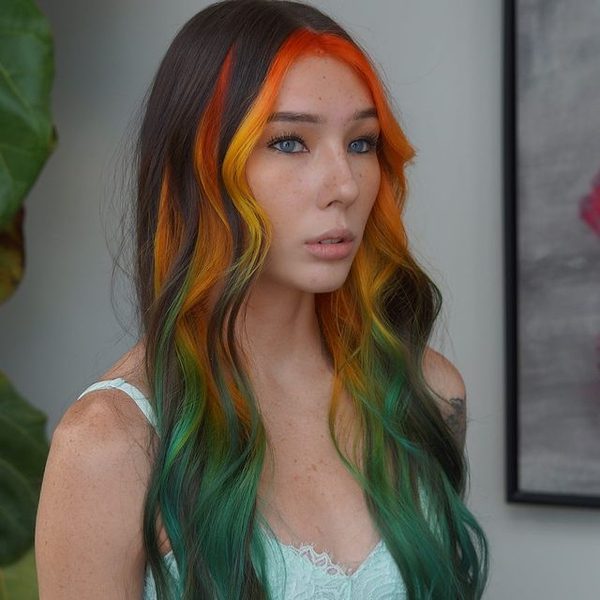 A woman wearing white lacey top - rainbow hair